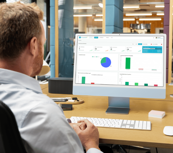 A team member reviewing the Credostar dashboard at their desk.